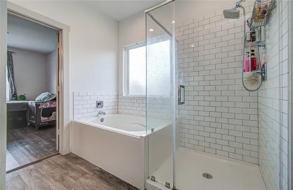 a spacious bathroom with a bathtub and shower