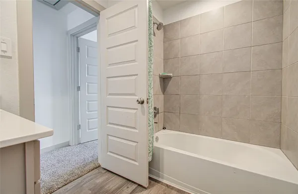 a bathroom with a bathtub and a shower