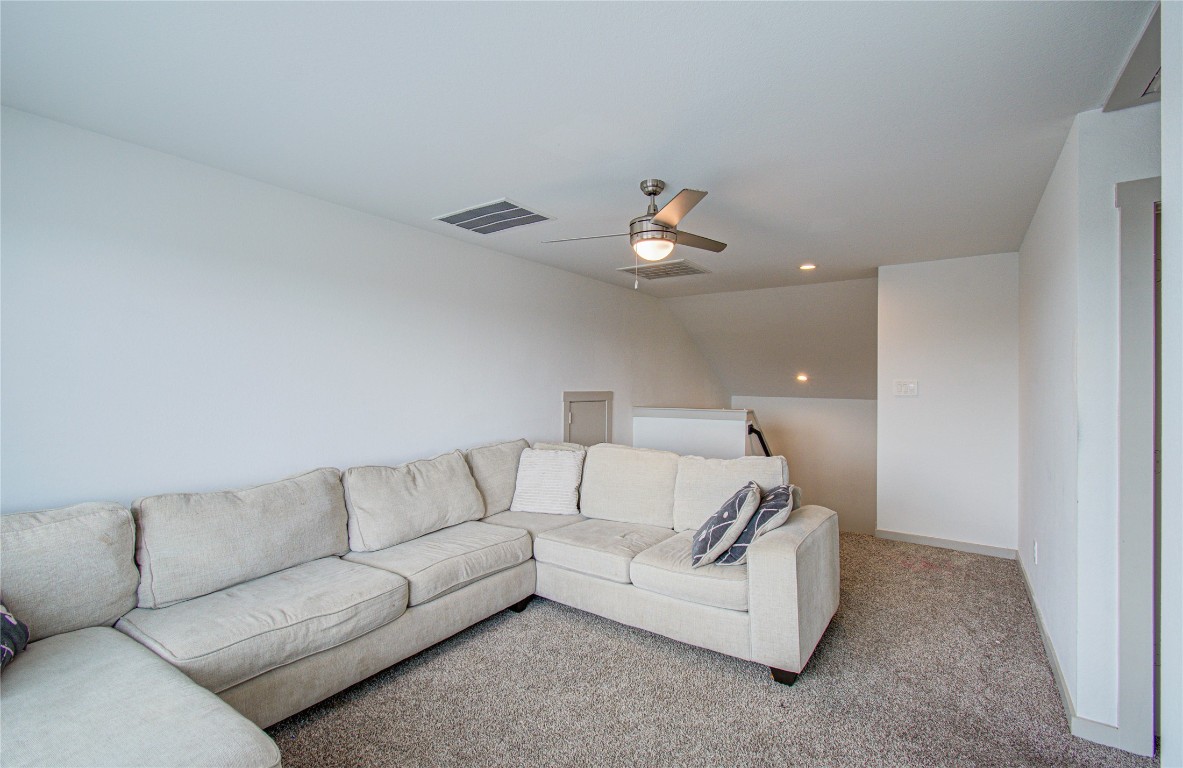 22 Desert Spring Lane Manvel, TX 77578 - Photo 32 of 36 a living room with furniture and a ceiling fan