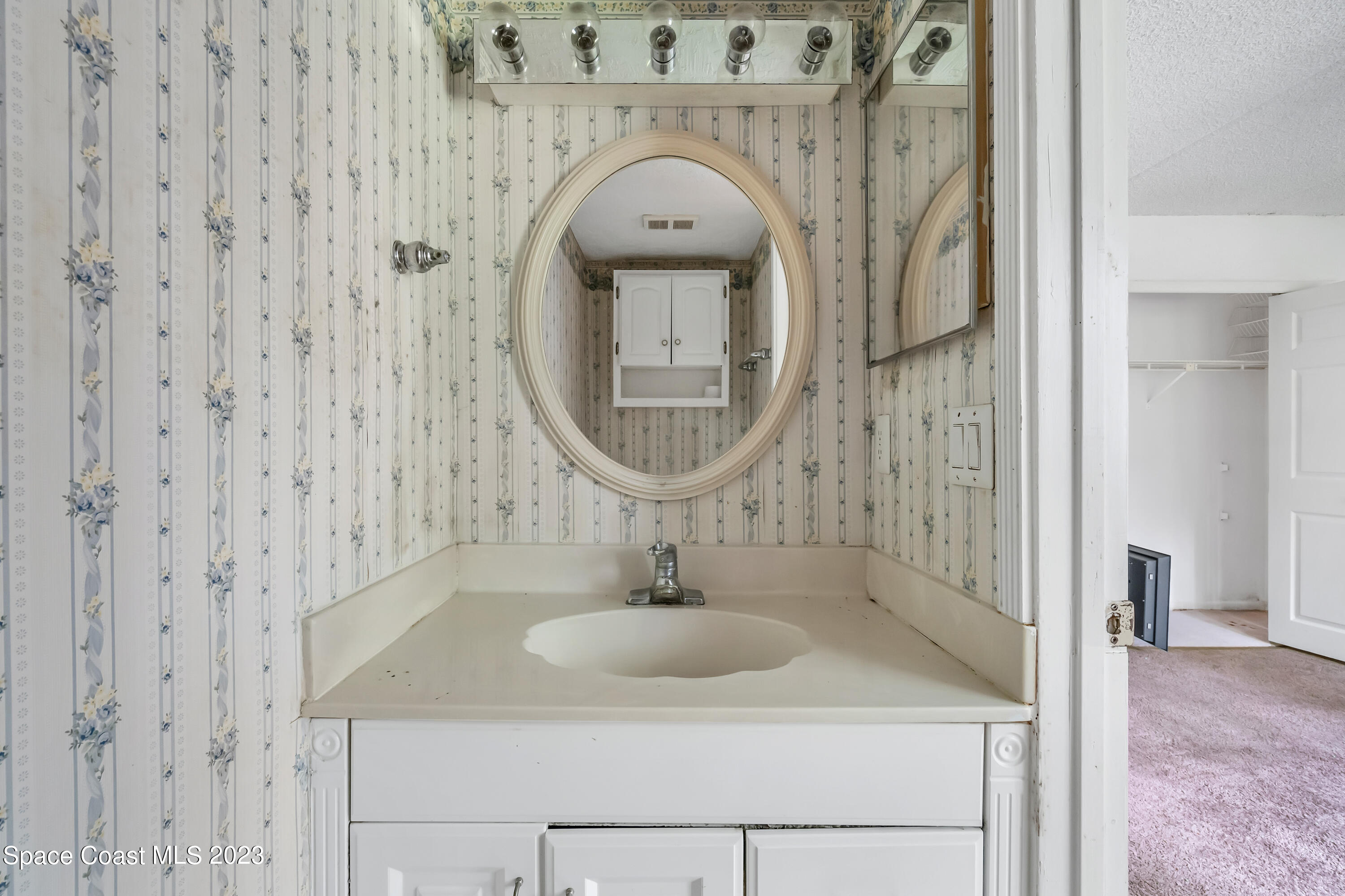 700 Ridge Club Drive, Unit 33 Melbourne, FL 32934 - Photo 17 of 32 a bathroom with a sink and a mirror