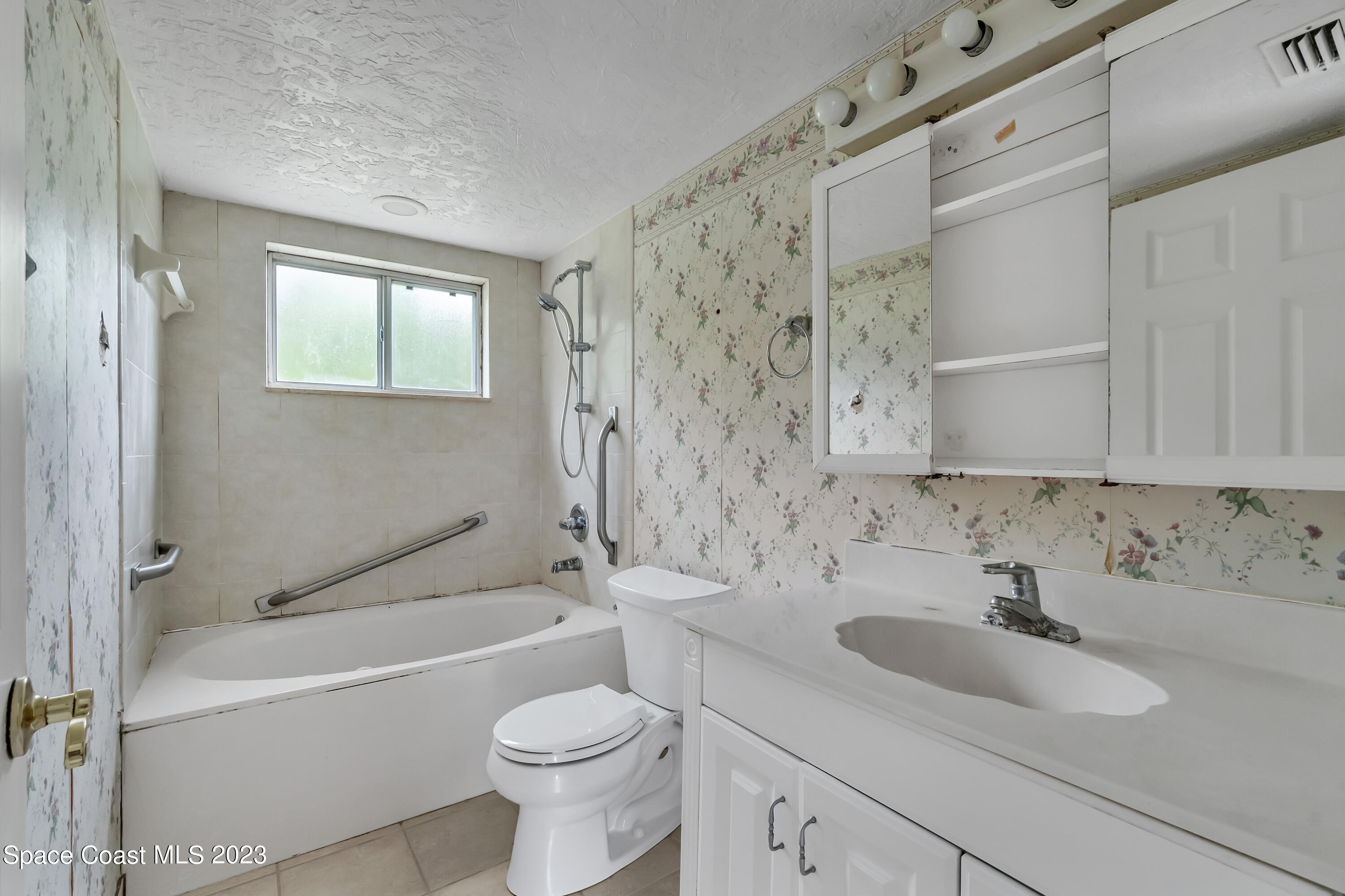 700 Ridge Club Drive, Unit 33 Melbourne, FL 32934 - Photo 22 of 32 a bathroom with a sink toilet and shower