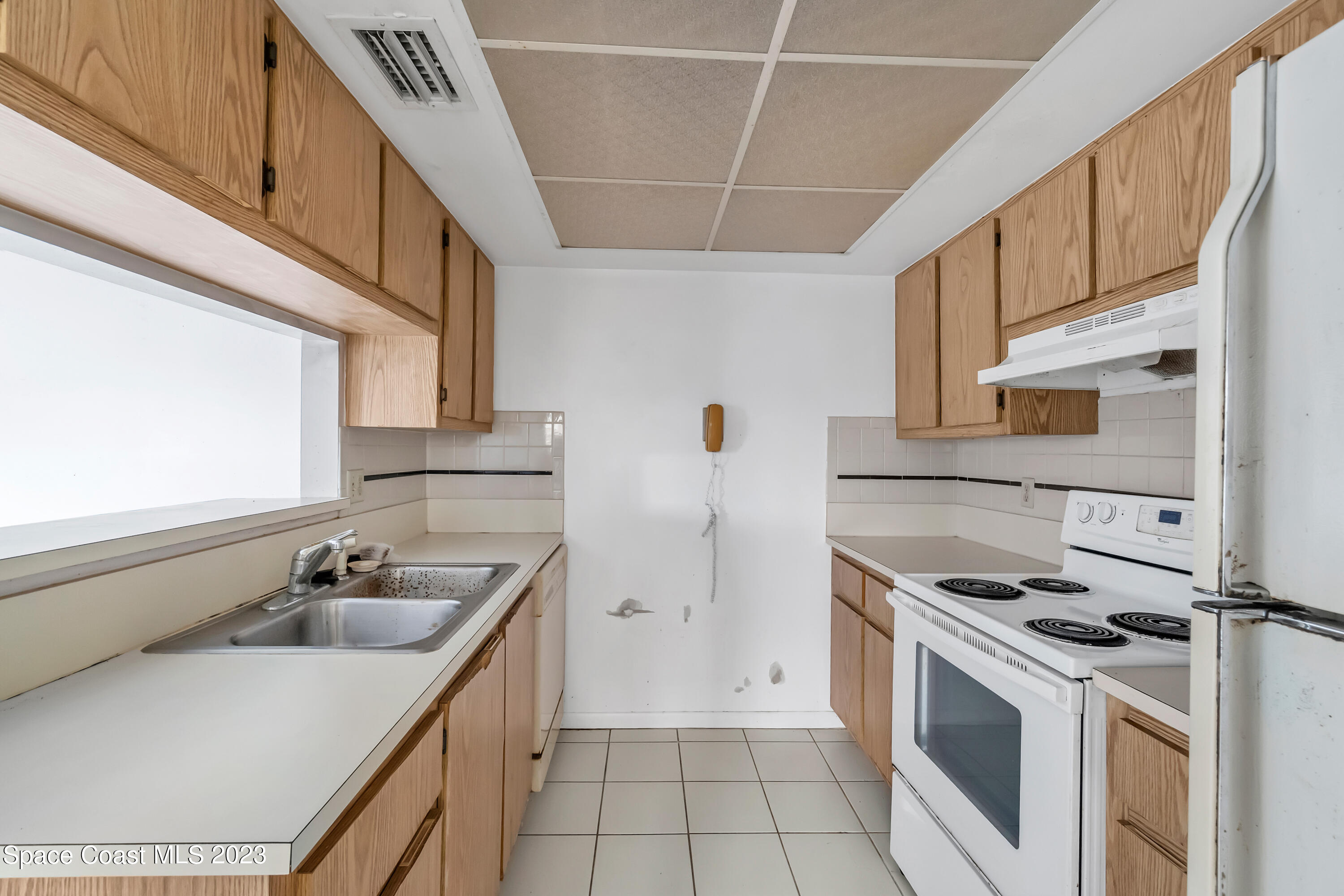 700 Ridge Club Drive, Unit 33 Melbourne, FL 32934 - Photo 5 of 32 a kitchen with stainless steel appliances a sink a stove a refrigerator and cabinets