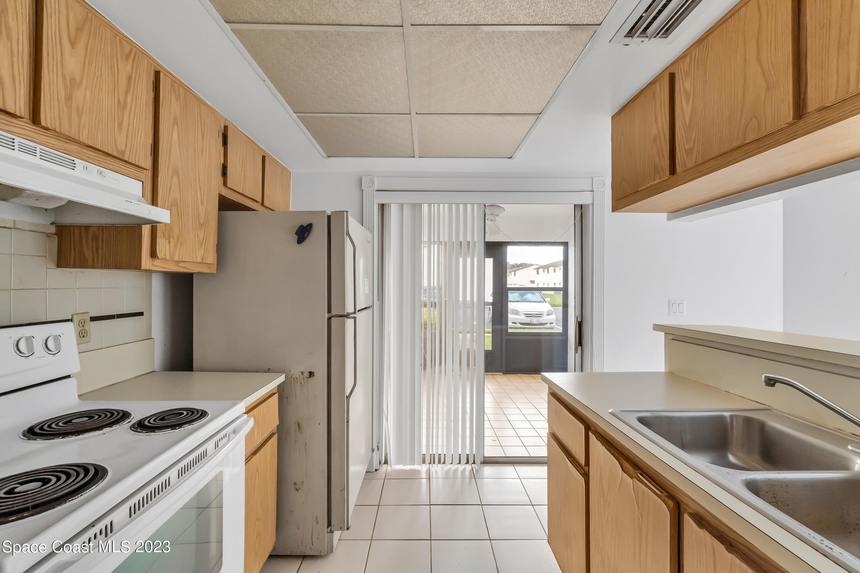 700 Ridge Club Drive, Unit 33 Melbourne, FL 32934 - Photo 6 of 32 a kitchen with a sink a refrigerator and cabinets