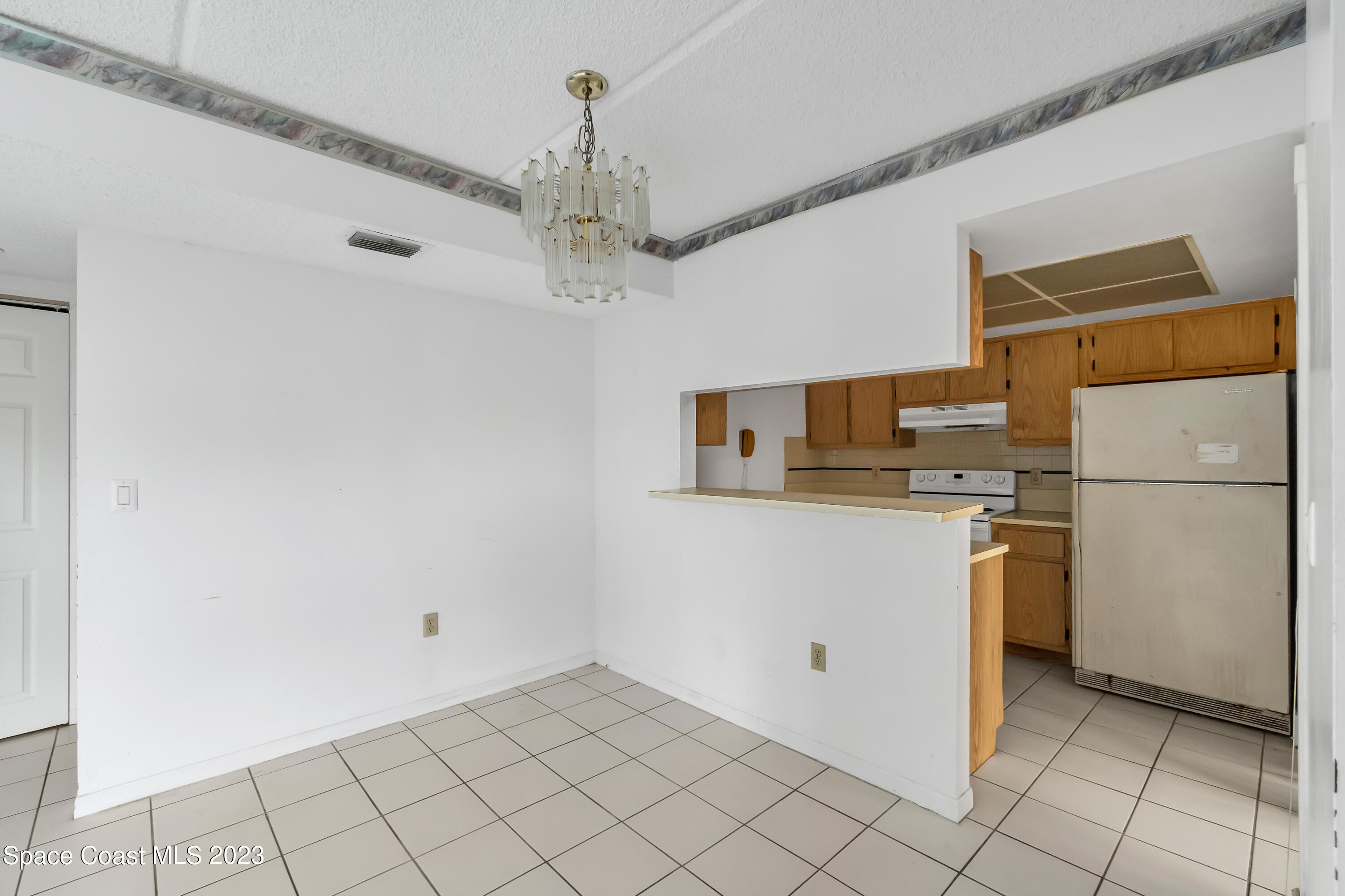 700 Ridge Club Drive, Unit 33 Melbourne, FL 32934 - Photo 8 of 32 a kitchen with stainless steel appliances a refrigerator and a stove top oven