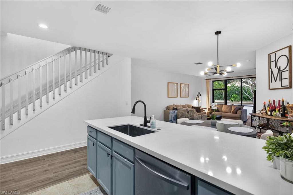 7845 Bristol Circle Naples, FL 34120 - Photo 10 of 31 a kitchen with counter top a sink and appliances