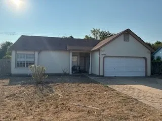 a view of a house with a yard and garage