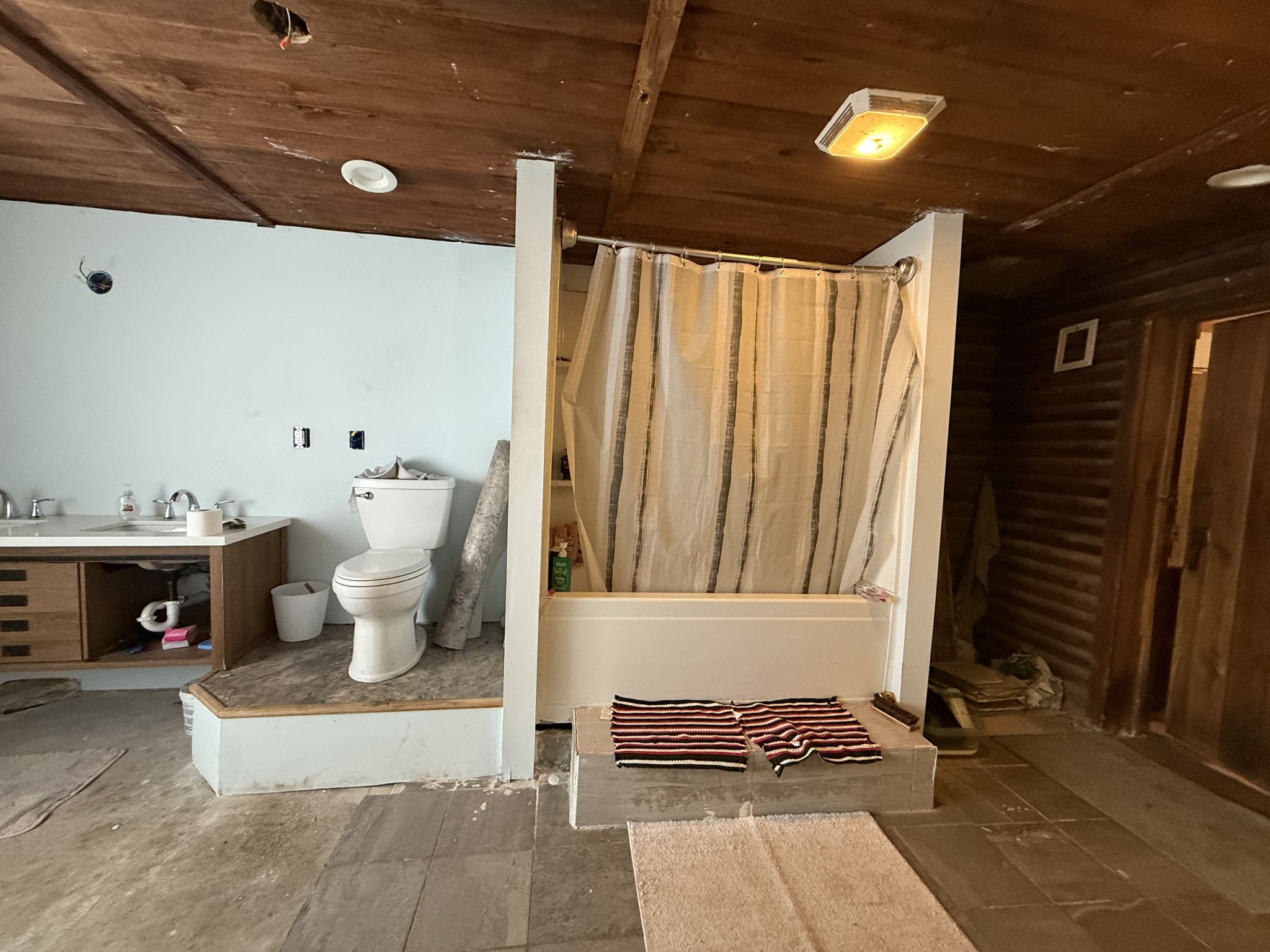 496 Rockhouse Road Hohenwald, TN 38462 - Photo 21 of 36 a view of a hallway with wooden floor and a potted plant