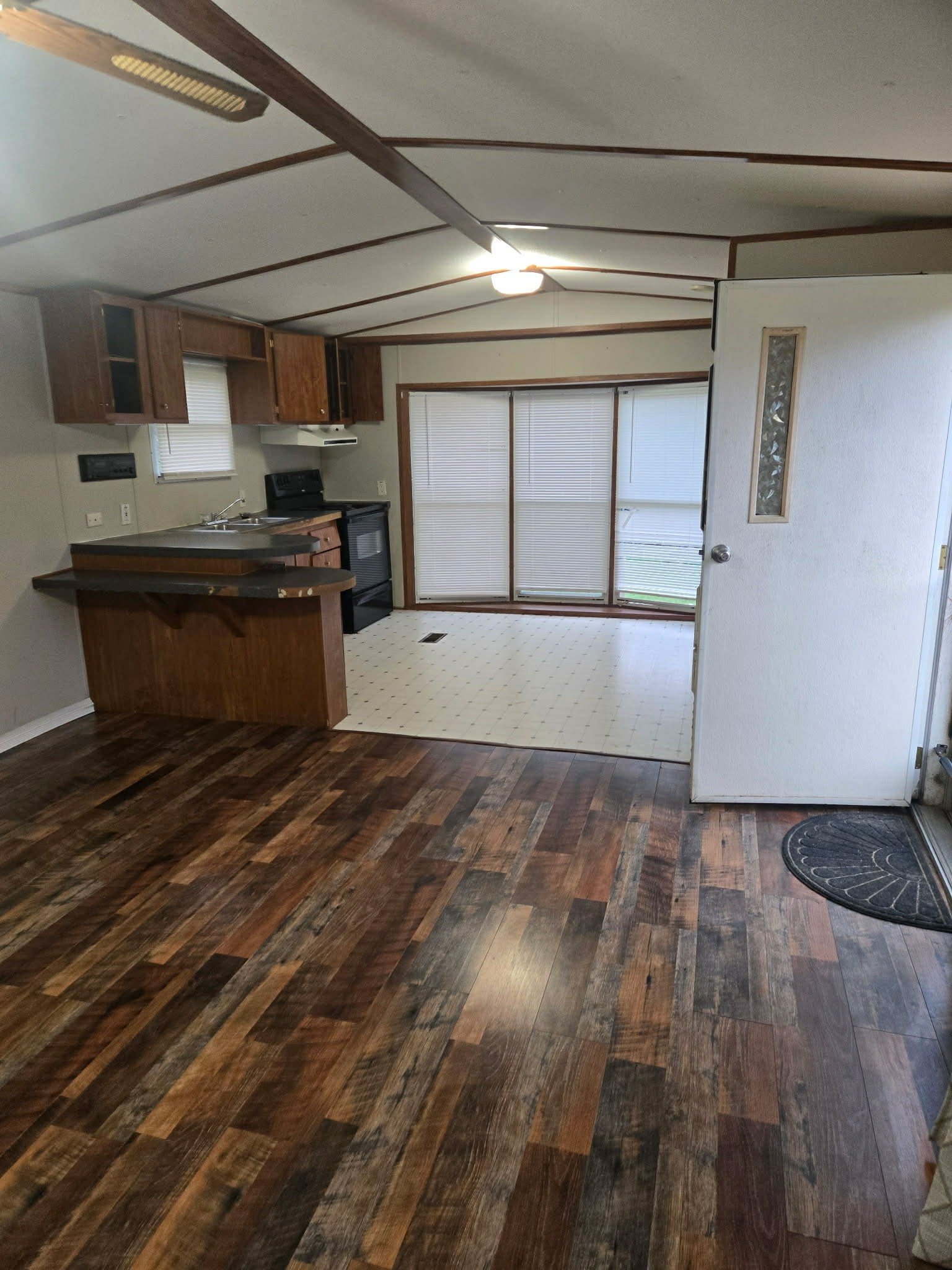 496 Rockhouse Road Hohenwald, TN 38462 - Photo 29 of 36 a kitchen with stainless steel appliances wooden cabinets a stove and a refrigerator