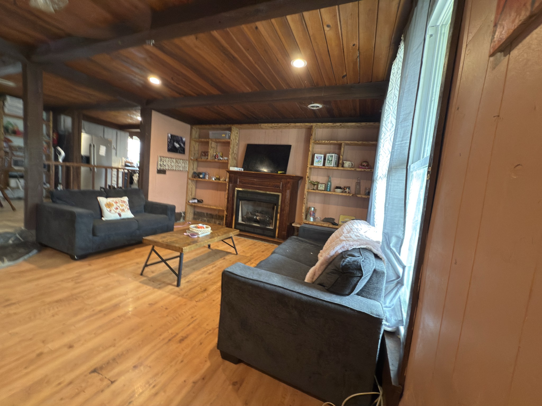 496 Rockhouse Road Hohenwald, TN 38462 - Photo 4 of 36 a living room with furniture and a fireplace