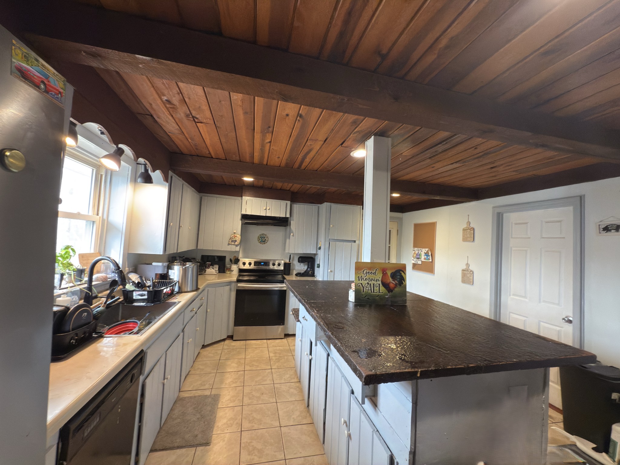 496 Rockhouse Road Hohenwald, TN 38462 - Photo 7 of 36 a kitchen with stainless steel appliances granite countertop a sink a stove and a refrigerator