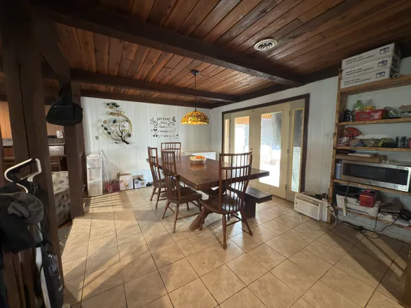 a dining room with furniture and window