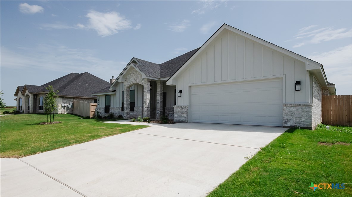 1404 Tahonta Drive Hewitt, TX 76643 - Photo 2 of 32 a front view of a house with a yard and garage