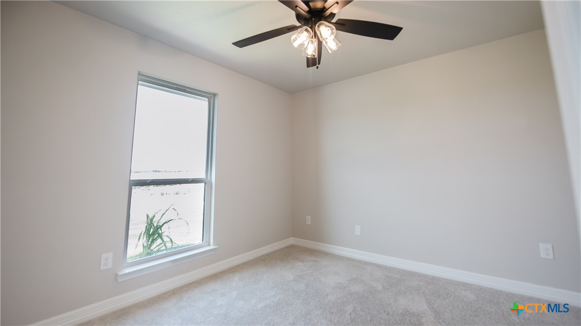 1404 Tahonta Drive Hewitt, TX 76643 - Photo 21 of 32 an empty room with windows and fan