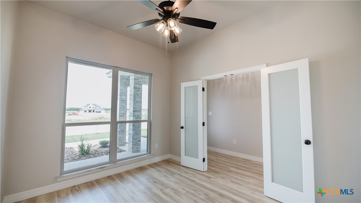 1404 Tahonta Drive Hewitt, TX 76643 - Photo 5 of 32 a view of an empty room with wooden floor and a window
