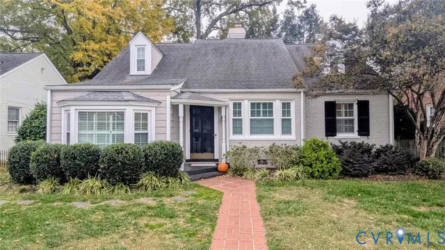 a front view of a house with yard and green space
