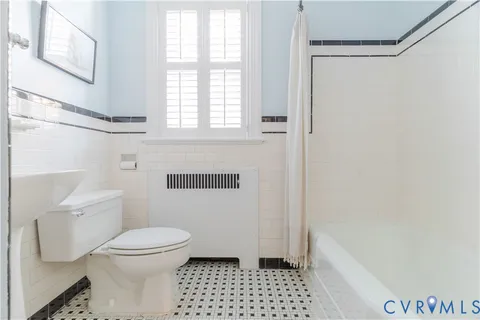 a bathroom with a toilet a sink and a bathtub