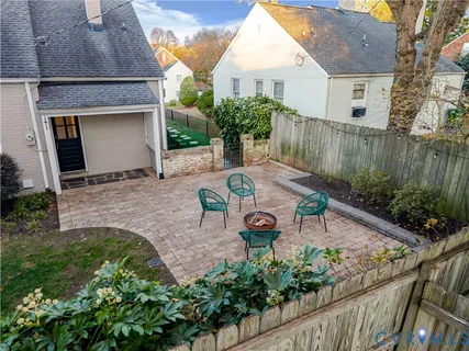 a view of a chair and table in backyard of the house