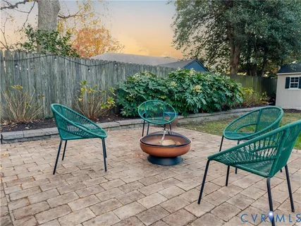 a view of a backyard with furniture and a fire pit
