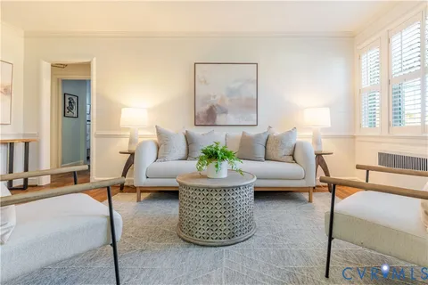a living room with furniture and a potted plant