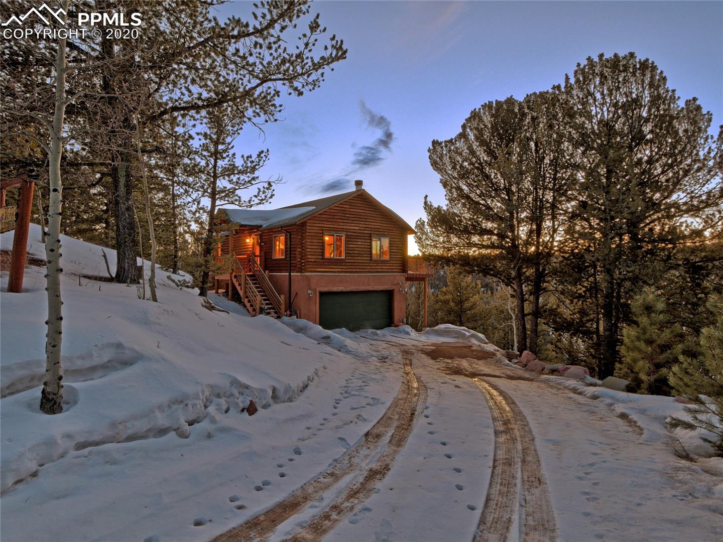 559 Timber Ridge Road Divide, CO 80814 - Photo 1 of 31 cozy, comfortable, modern log home, tastefully decorated in a mountain lodge décor. The cabin features wood floors, vaulted ceilings, log and leather furnishings. Step into the Great Room to a stunning floor to ceiling natural stone fireplace and the many windows frame beautiful views of the surroundings.