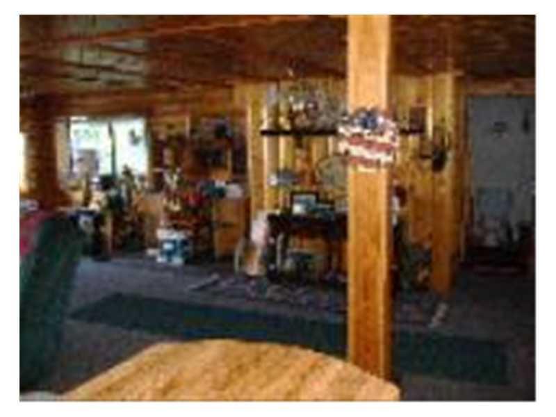 343 Turkey Tail Road Millinocket, ME 04462 - Photo 9 of 23 Living Room. East Wall Knotty Pine
