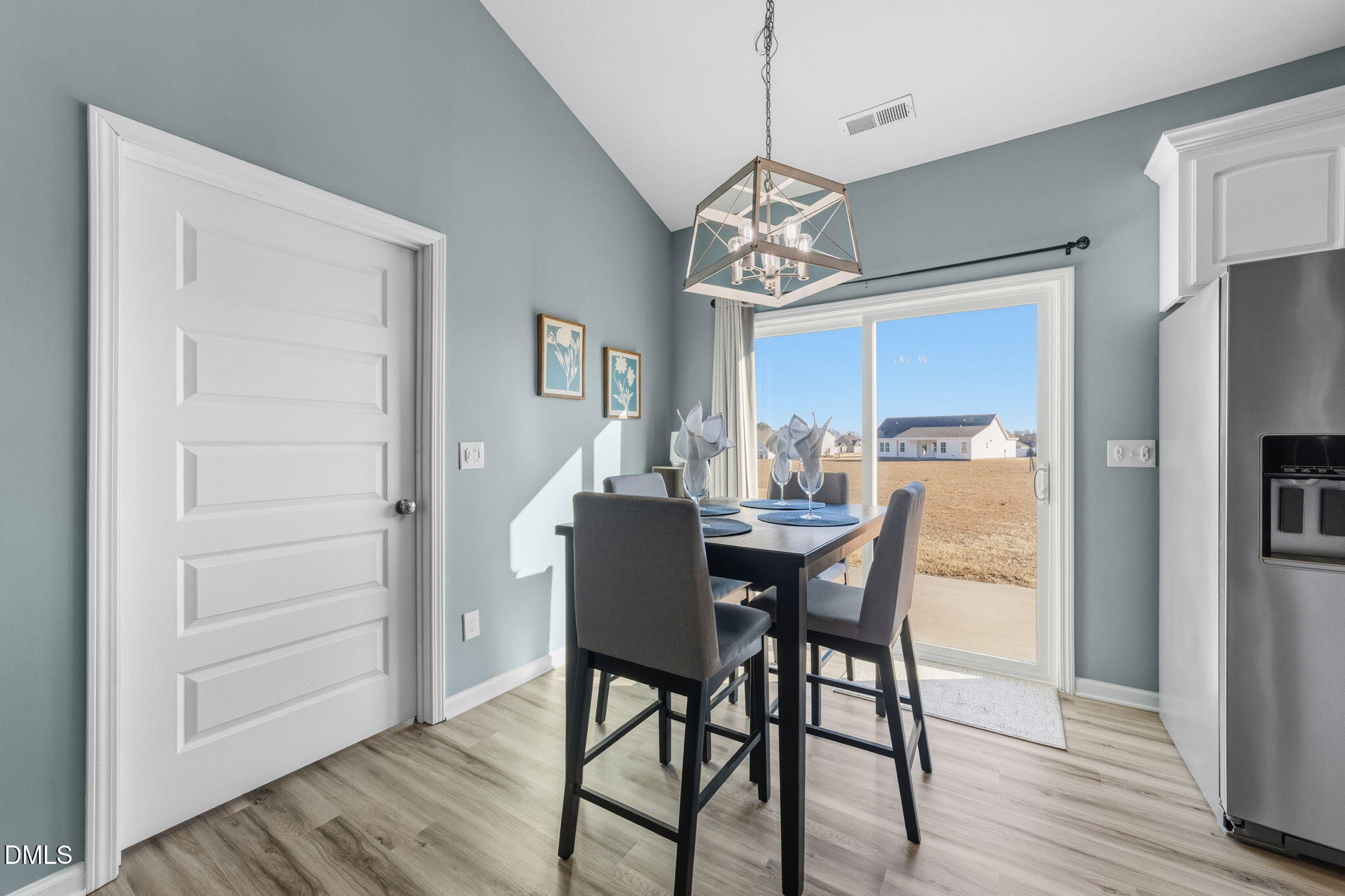 4029 Needham Road Bailey, NC 27807 - Photo 13 of 21 a view of a dining room with furniture a chandelier and wooden floor