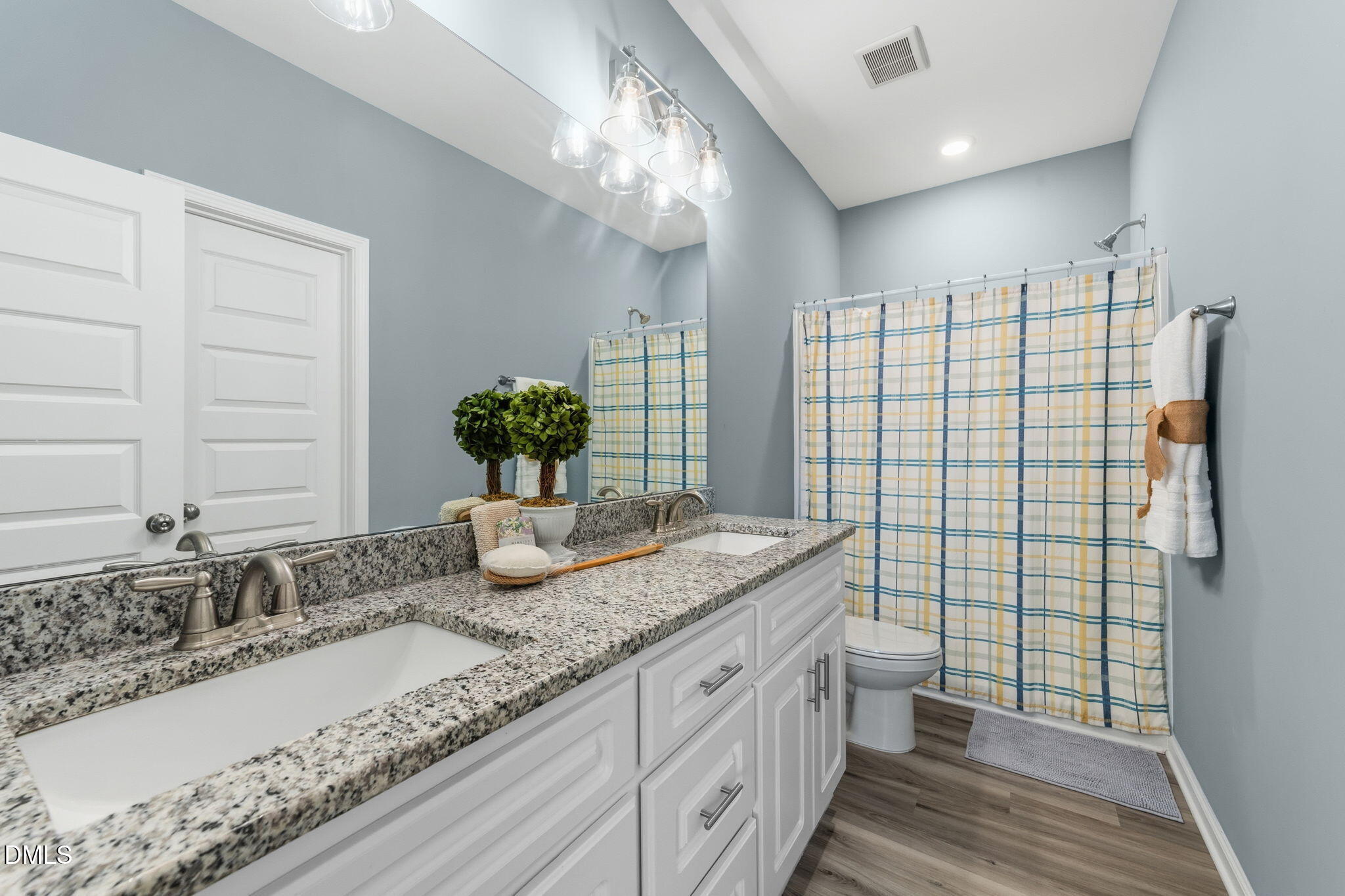 4029 Needham Road Bailey, NC 27807 - Photo 15 of 21 a bathroom with a granite countertop sink a large mirror and a shower