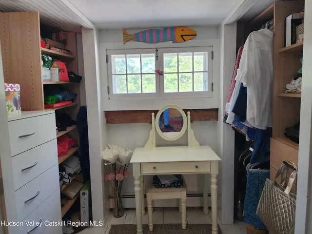 a view of walk in closet with clothes and shoes