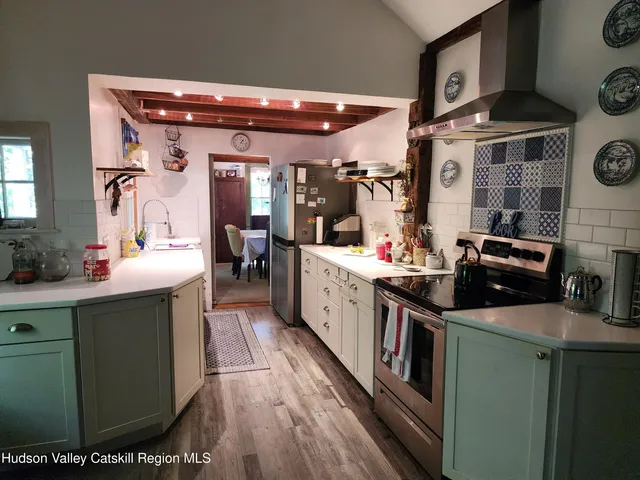 a kitchen with stainless steel appliances granite countertop a sink and cabinets