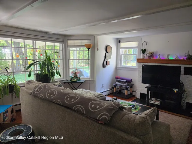 a bedroom with furniture and a flat screen tv