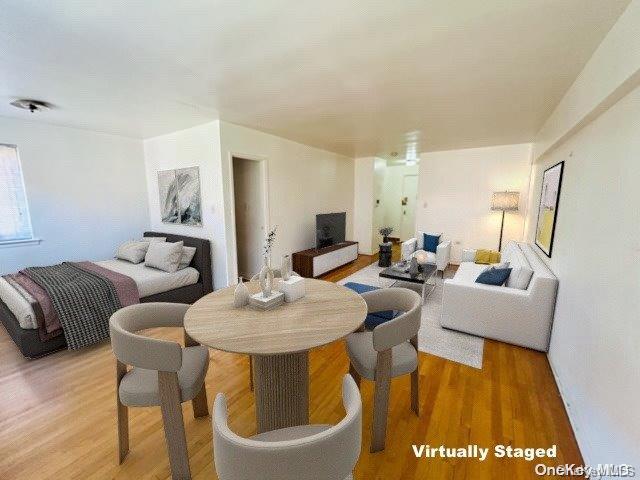 99-10 60th Avenue, Unit 5L Queens, NY 11368 - Photo 4 of 13 a living room with furniture and a table