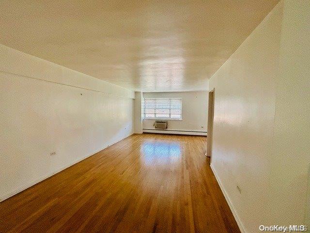 99-10 60th Avenue, Unit 5L Queens, NY 11368 - Photo 7 of 13 wooden floor in a empty room