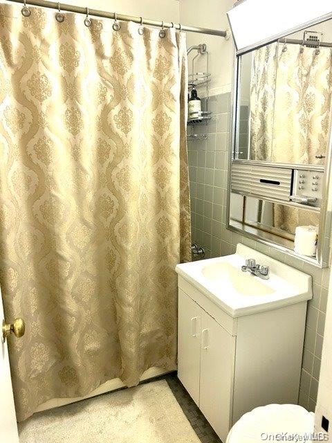 99-10 60th Avenue, Unit 5L Queens, NY 11368 - Photo 9 of 13 a bathroom with a sink a toilet and shower