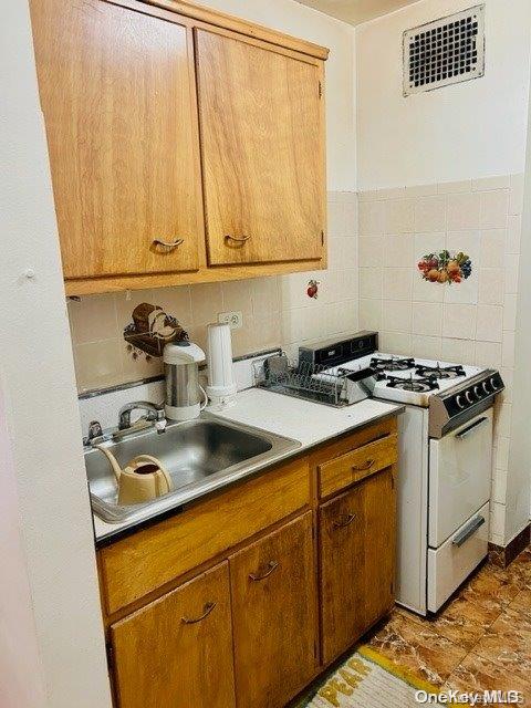 99-10 60th Avenue, Unit 5L Queens, NY 11368 - Photo 10 of 13 a kitchen with a sink and cabinets