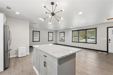 a kitchen with a stove a sink and a refrigerator