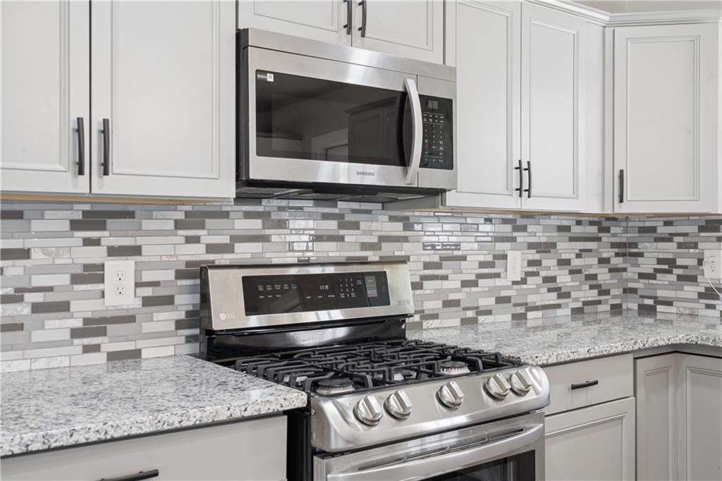 2357 Scotty Circle Decatur, GA 30032 - Photo 20 of 44 a kitchen with granite countertop a stove sink and microwave