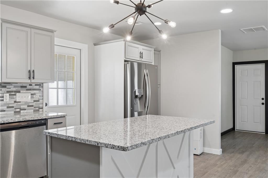 2357 Scotty Circle Decatur, GA 30032 - Photo 24 of 44 a kitchen with stainless steel appliances granite countertop a sink refrigerator and cabinets