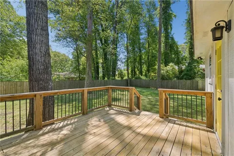 a view of balcony with wooden floor and fence