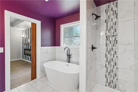 a bathroom with a bathtub and shower