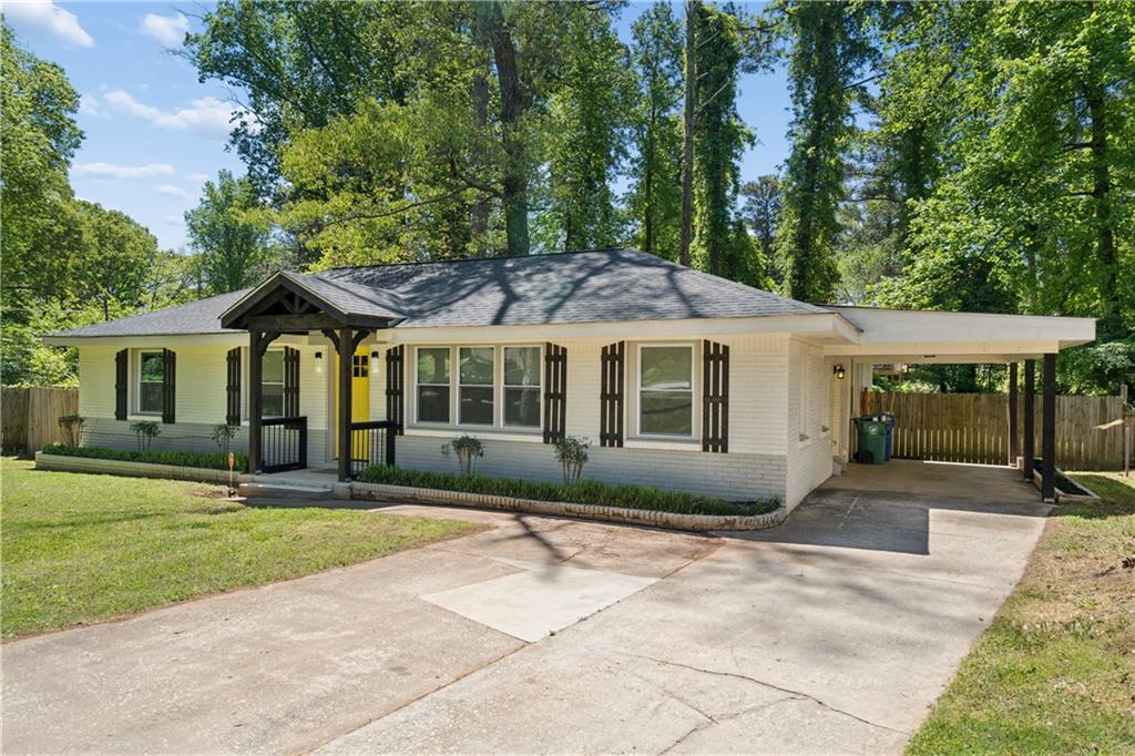 2357 Scotty Circle Decatur, GA 30032 - Photo 3 of 44 a front view of a house with a garden and trees