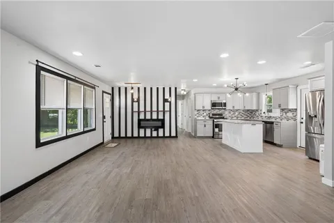 a view of kitchen with wooden floor and electronic appliances