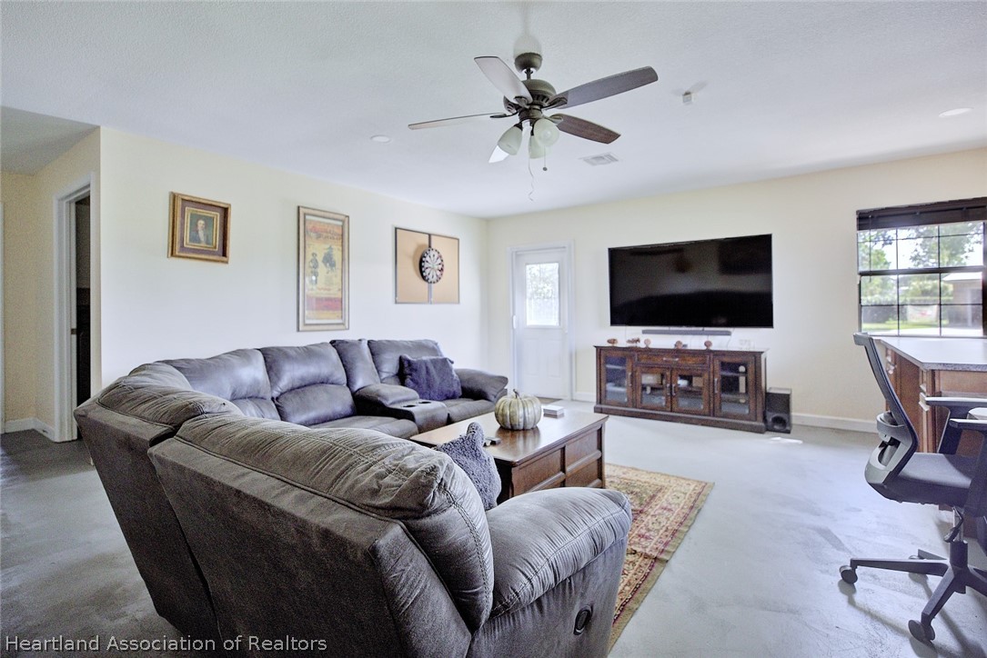 3601 Divot Road Sebring, FL 33872 - Photo 16 of 31 a living room with furniture and a flat screen tv