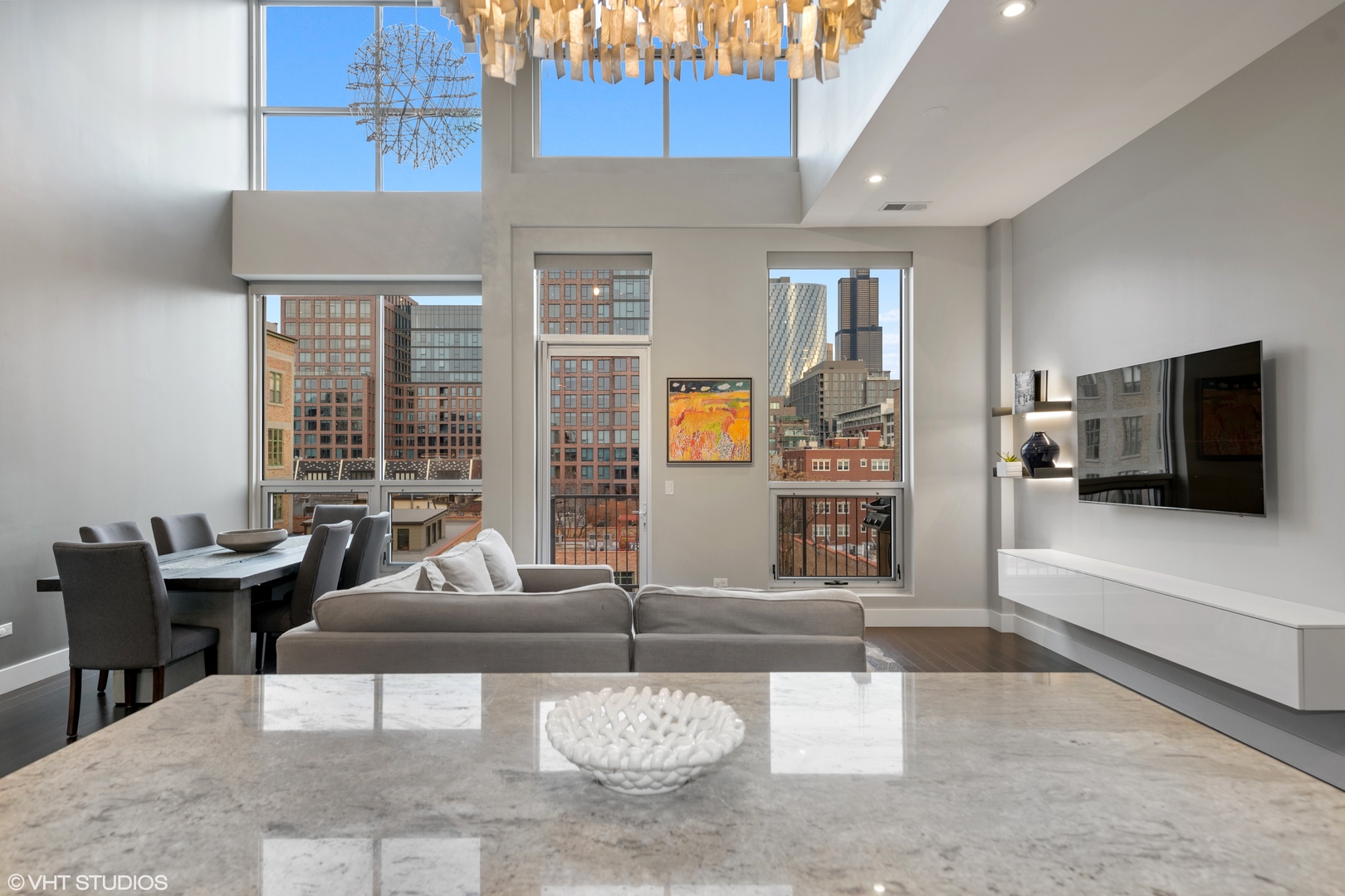 18 North Carpenter Street, Unit PHS Chicago, IL 60607 - Photo 2 of 33 a living room with furniture and a flat screen tv
