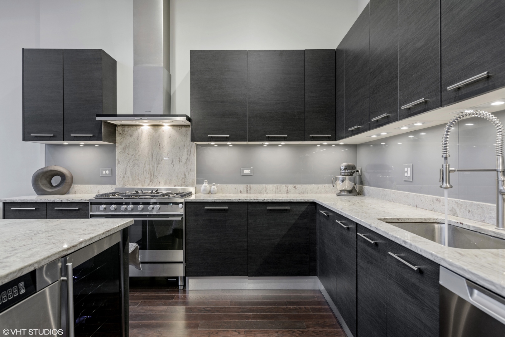18 North Carpenter Street, Unit PHS Chicago, IL 60607 - Photo 12 of 33 a kitchen with stainless steel appliances granite countertop a sink stove and refrigerator