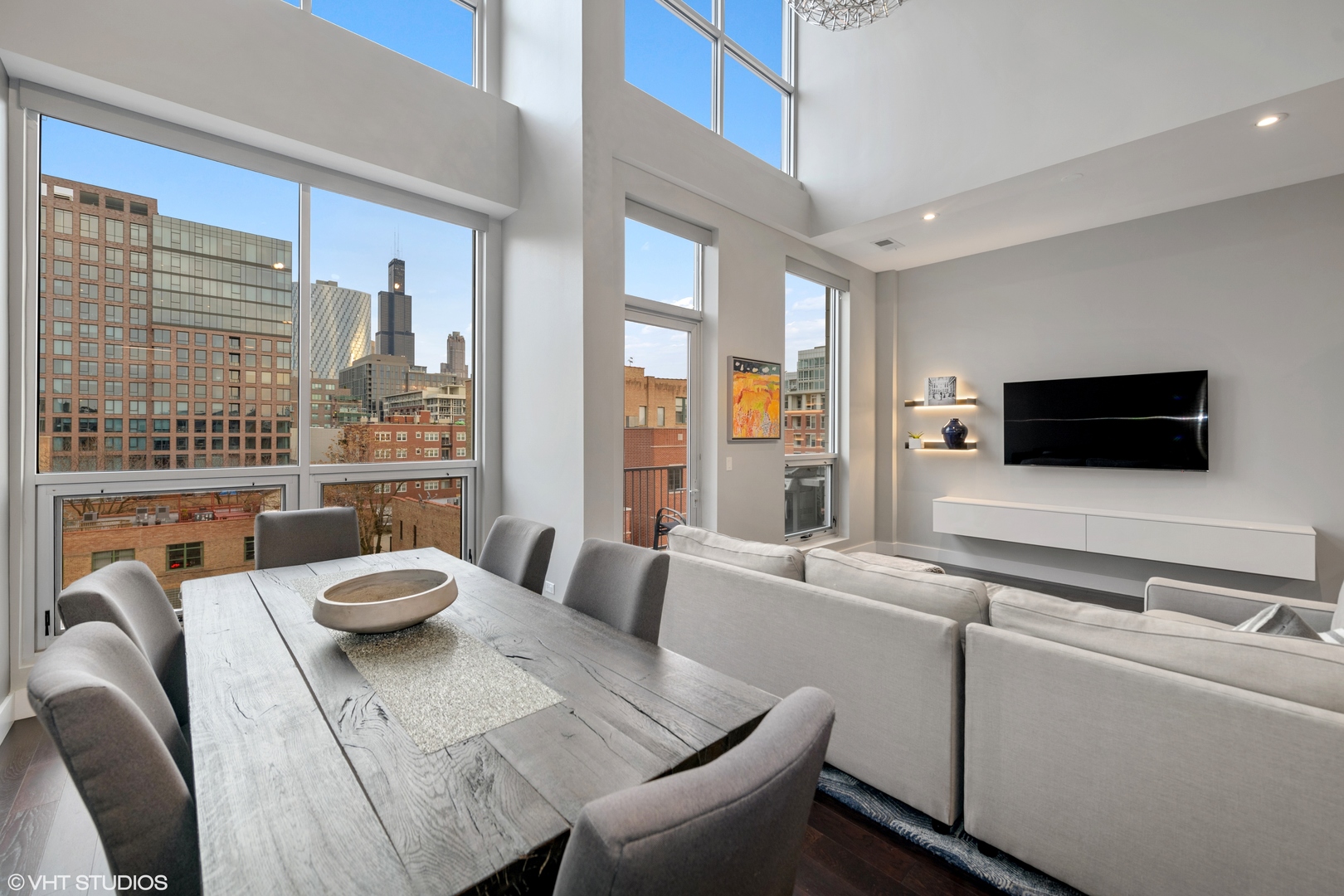 18 North Carpenter Street, Unit PHS Chicago, IL 60607 - Photo 4 of 33 a living room with furniture and a flat screen tv