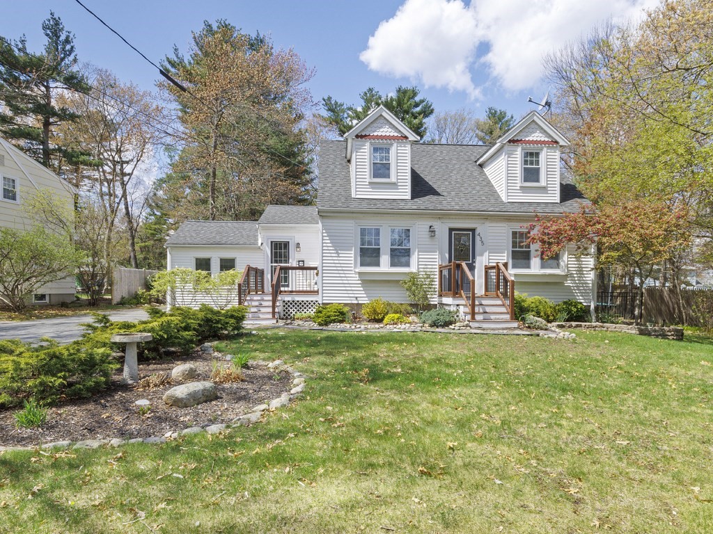 a front view of a house with swimming pool having outdoor seating