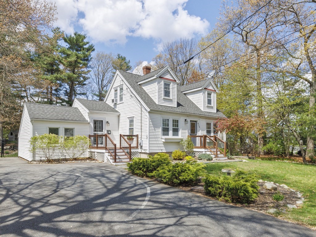 435 Old Post Road Walpole, MA 02081 - Photo 2 of 36 a front view of a house with a yard and potted plants