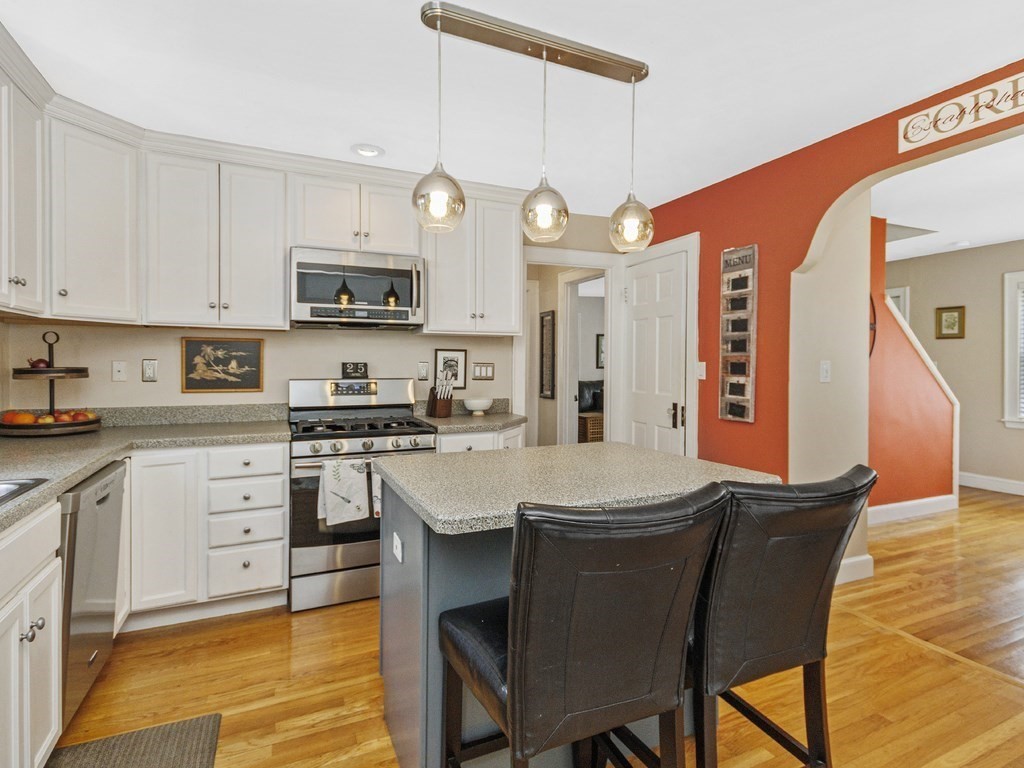 435 Old Post Road Walpole, MA 02081 - Photo 5 of 36 a kitchen with stainless steel appliances kitchen island granite countertop a sink a stove a table and chairs
