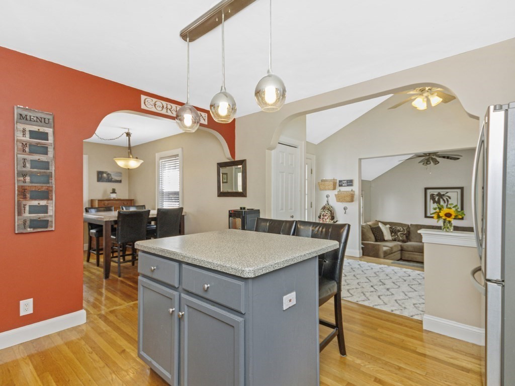 435 Old Post Road Walpole, MA 02081 - Photo 7 of 36 a kitchen with a sink dishwasher a stove and a dining table with wooden floor
