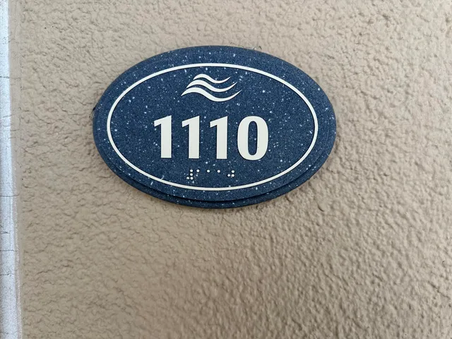 a living room with furniture a flat screen tv and a large window